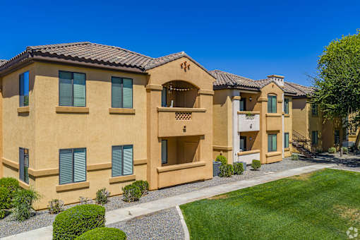 A row of houses with a clear blue sky above them.