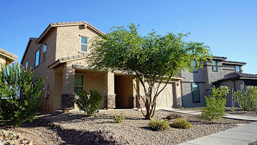 A house with a tree in front of it.