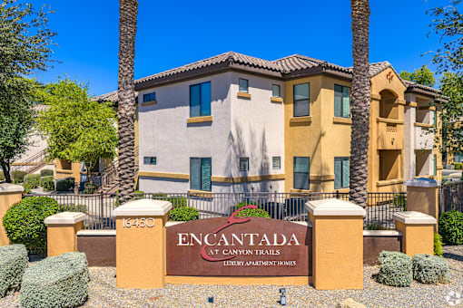 A sign that says Encantada in front of a building.