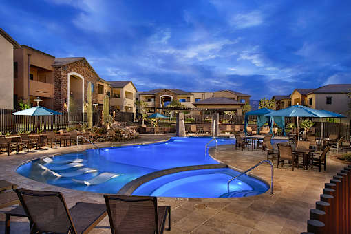 A luxury apartment swimming pool with shallow end loungers