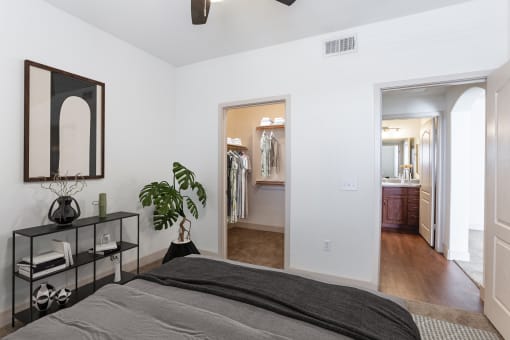 a bedroom with a large bed and a doorway into a bathroom