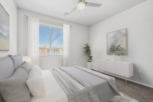 a bedroom with a large white bed and a large window