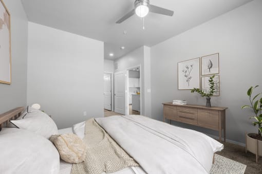 a bedroom with a large bed and a ceiling fan