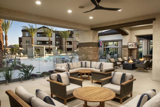 a lobby with couches and tables and a swimming pool