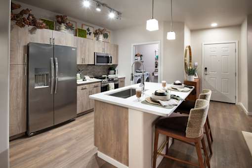 A modern kitchen with a dining table set for four.