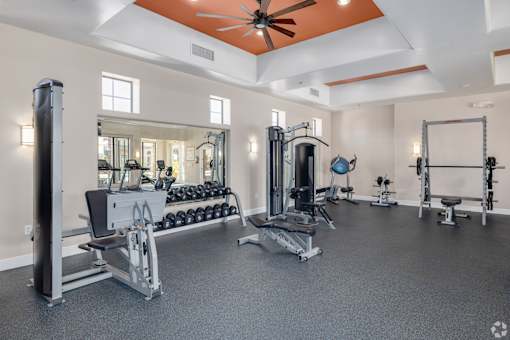 A spacious home gym with a variety of exercise equipment.