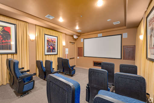 A room with a screen and chairs.