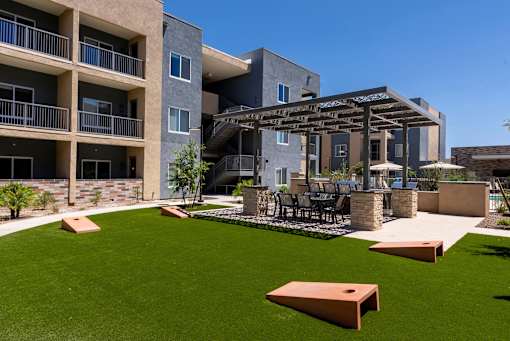 A modern building with a patio and a pergola.