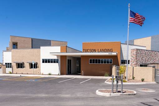 The Tucson Landing building has a flag flying in front of it.