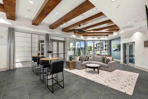 A modern living room with a dining area and a balcony.