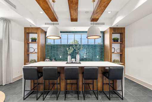 A modern dining room with a long table and chairs.