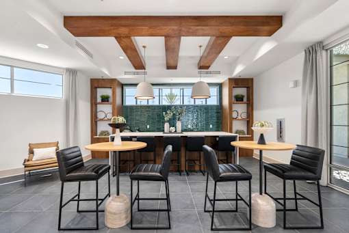 A modern dining room with a round table and chairs.