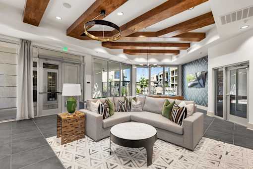 A modern living room with a wooden ceiling and a large window.