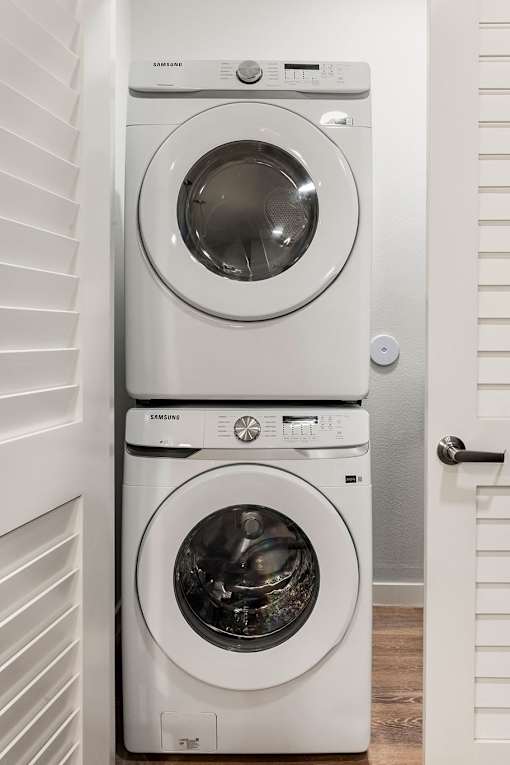 Two Samsung front load washing machines in a laundry room.