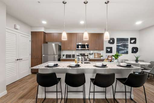 A modern kitchen with a dining table set for four.