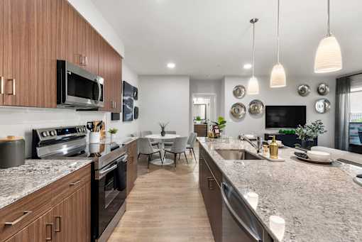 A modern kitchen with dark wood cabinets and stainless steel appliances.