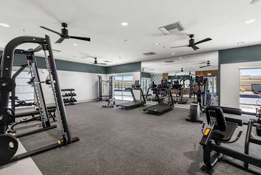 A spacious gym with a variety of equipment including treadmills, weights, and exercise machines.