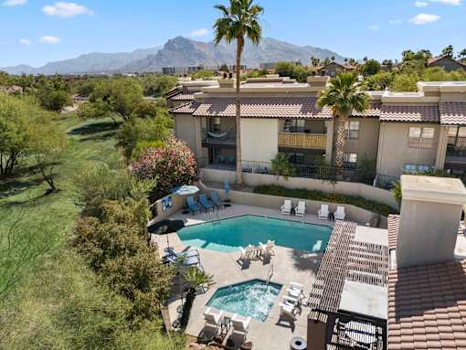 A pool and patio area with a mountain in the background.