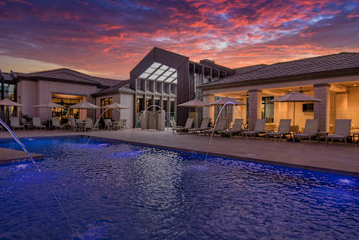 A large house with a pool in the foreground.