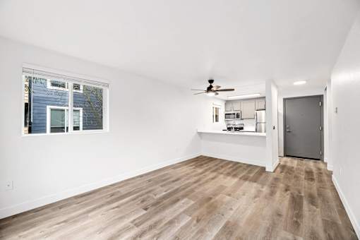 A room with a ceiling fan and a window.