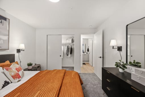 a bedroom with a bed and a dresser and a closet