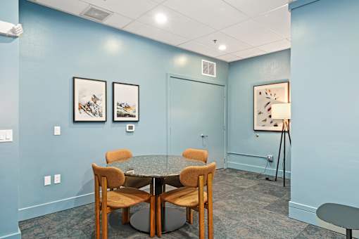 A room with a table and chairs.