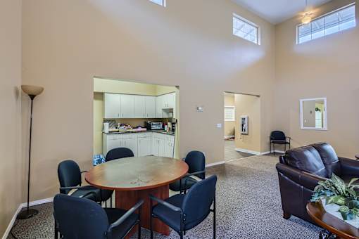 A dining room with a round table and chairs.