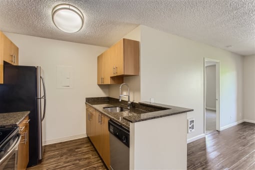 a kitchen with a sink and a refrigerator