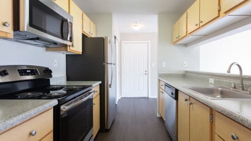 a kitchen with a sink and a stove and a refrigerator
