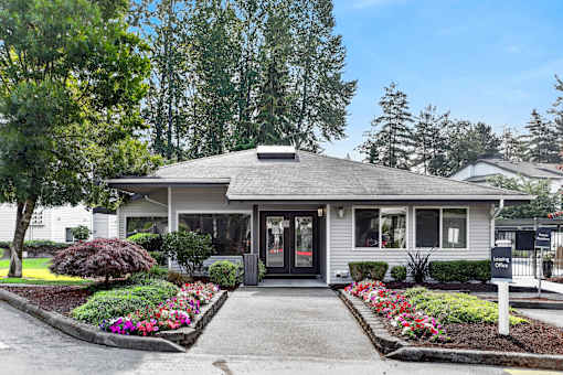 A house with a front yard and a sign that says "One".