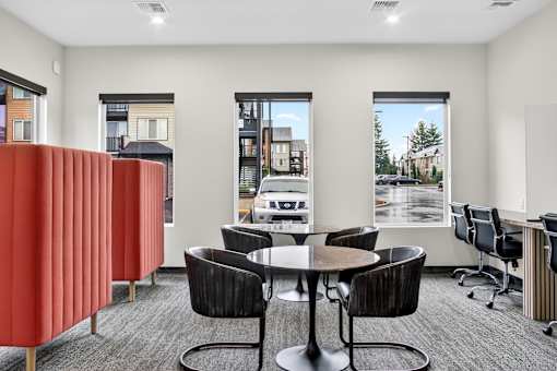 A conference room with a table surrounded by chairs.