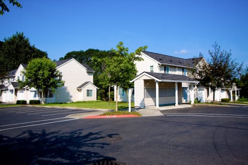 a row of white houses in a parking lot