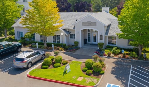 a large white building with cars parked in front of it