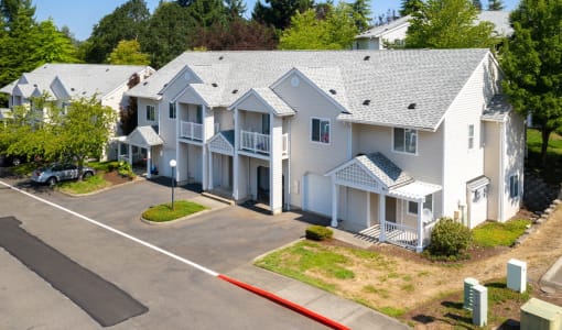 an aerial view of a row of white houses on a street