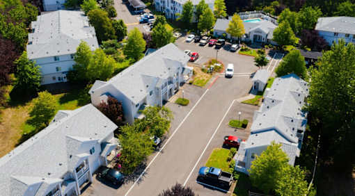 A bird's eye view of a residential area with houses and cars.