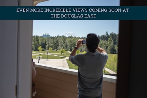 a rooftop bar with a view of the space needle in the city