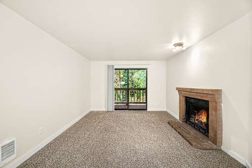 A room with a fireplace and a window.
