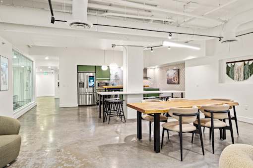 A conference room with a long table and chairs.
