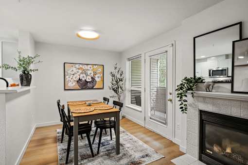 A dining room with a table and chairs.