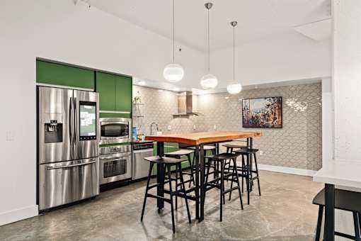 A kitchen with a table and chairs.