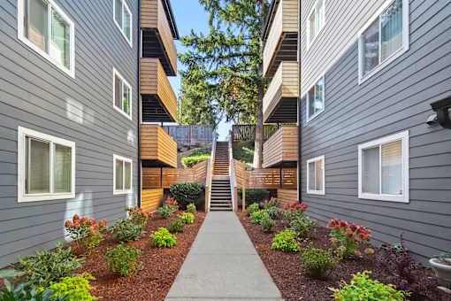 A long concrete pathway leads between two rows of houses.