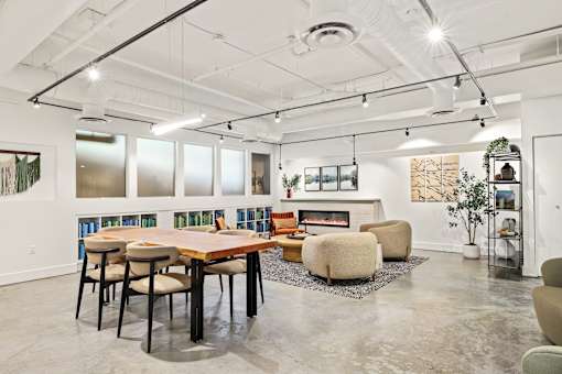 A modern room with a long table and chairs.