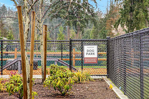 A sign that says "PORTER DOG PARK" is on a fence.