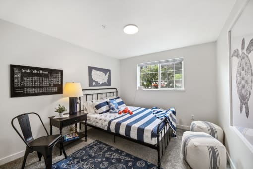 a bedroom with a bed and a chair and a window