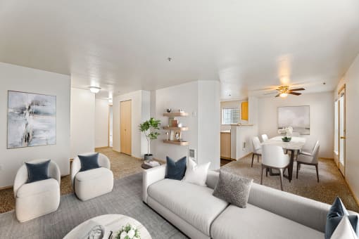 a living room with couches and chairs and a dining table
