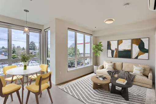 a living room with a couch and a table with chairs