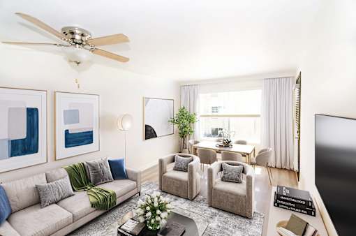 a living room with a couch and chairs and a table