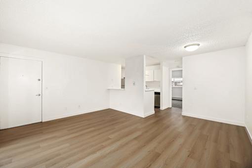 A room with wooden floors and white walls.
