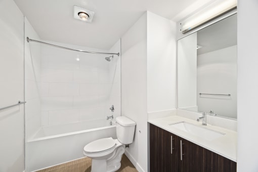 a bathroom with a shower toilet and sink