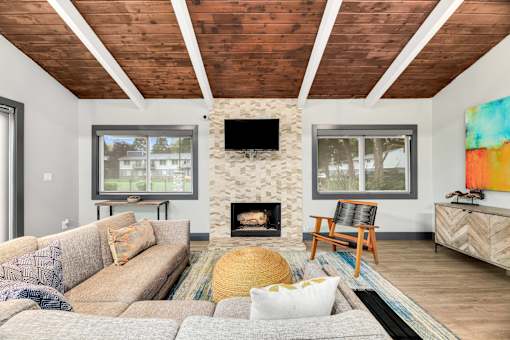 A living room with a fireplace and a television on the wall.